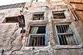 The windows of one of the remaining houses in Qatif Castle, displaying visible cracks and crevices.