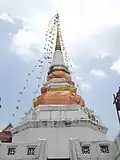 Another minor chedi on the junk, decorated with flags