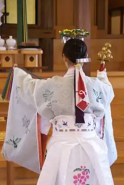 Miko with suzu bells in her right hand