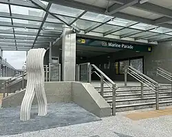 Entrance 3 of the station, with the artwork shaped like a white block of plasticine