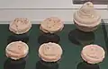 Five clay tsha-tsha and one miniature stupa model