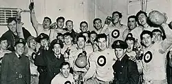 Photograph of the RCAF Hurricanes team celebrating their 1942 Grey Cup Win