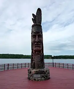 Nee-Gaw-Nee-Gaw-Bow (Leading Man), by Peter Wolf Toth (1988), to honor the Ojibwe people; it is located on the lakeside pier next to the Wakefield Visitor’s Center and was carved from one piece of pine donated by the Ottawa National Forest. It is one of Toth's Whispering Giants.
