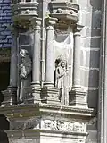 The right side buttress by the south porch. We see a monk holding a book in the left niche and a bishop in the right niche.