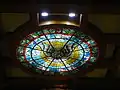 Stained glass depicting the Holy Spirit on the ceiling above the altar