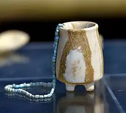 Alabaster jar with a necklace from Tell es-Sawwan, Iraq. 6000-5800 BCE. Iraq Museum