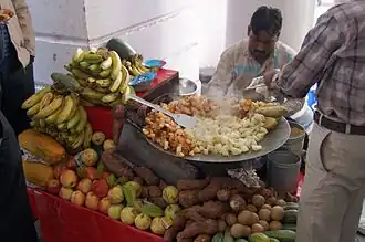 Aloo chaat being cooked in a large tava