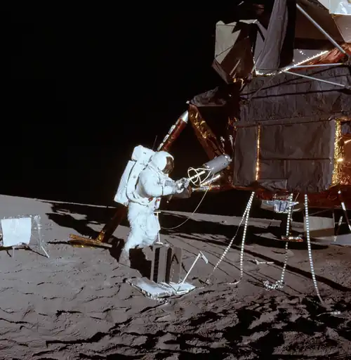 Apollo 12 astronaut Alan Bean unloads the plutonium core that powered the ALSEP on the Ocean of Storms.