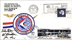 A rectangle with the headline "An Apollo 15 Flown Lunar Postal Cover" with a logo in the middle. Below it are two smaller frames. One has some text certifying that what was below was flown to the Moon and back, signed by flight commander David Scott. Below it is an envelope with stamps, logos and, postmarks.