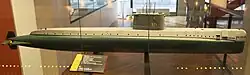 The world's first nuclear submarine, the USS&nbsp;Nautilus&nbsp;(SSN-571) of 1954, shows a very clean stern section, while the bow is clearly to some extent inspired by the Type XXI. Her test depth of 210&nbsp;m was comparable to the German boat, but at 23&nbsp;kn (43&nbsp;km/h) submerged she was faster by far, even faster than any previous US fleet boat had been on the surface. Unfortunately, serious design flaws in her bow and sail resulted in extreme vibrations at high speed, and worsened over time. At the end of her life 4&nbsp;kn (7&nbsp;km/h) was enough to deafen her sonar, and the noise drastically increased the risk of detection.