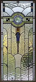 An Art Deco domestic casement window, Melbourne, Australia, shows a wide variety of textured glass with some streaky glass in muted colours.