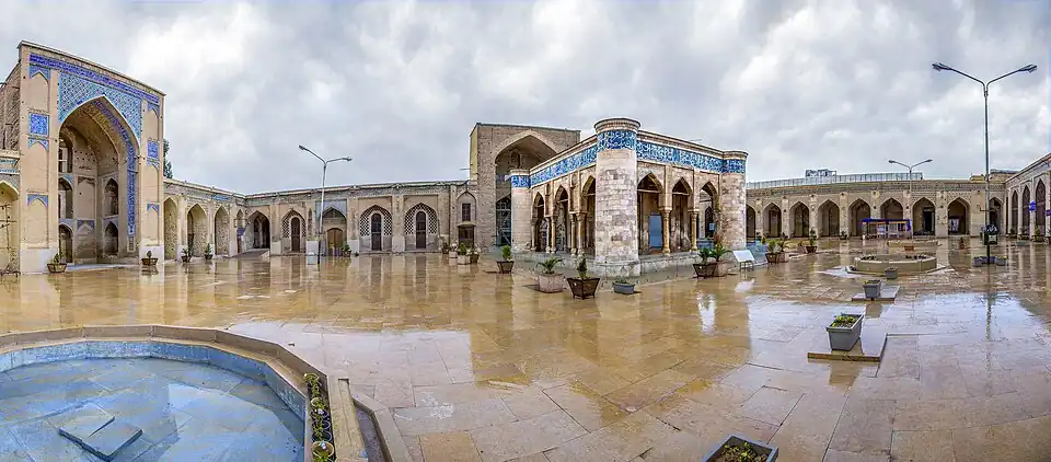 Decorative image of tiled courtyard and arabesque motifs of the portals of the mosque
