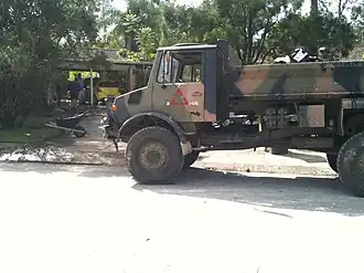 Photograph of a large truck in front of a house