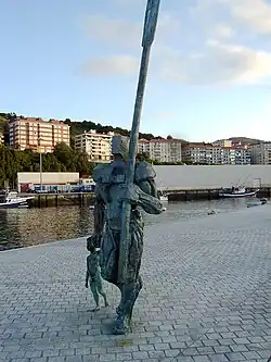 Statue of a man carrying a large oar