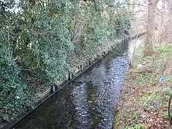 The Beverley Brook looking downstream from the Motspur Park/West Barnes Lane road bridge.