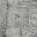 A medieval mass dial (minus its gnomon) at St. Mary, Bibury; also known as a scratch dial, it was used to tell the times of Mass.