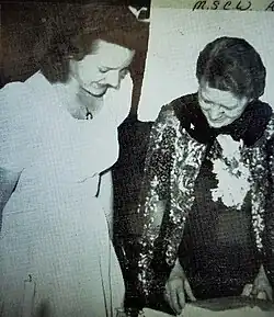 Williams (right) is presented birthday present by student president at her alma mater (1941).