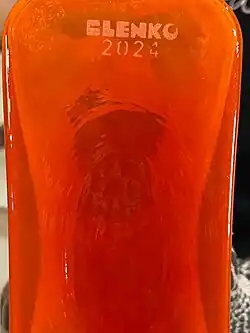 Blenko 2024, with unusual font, added to bottom of orange glass bottle