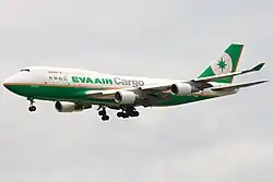 Double-deck aircraft in flight, with deployed landing gear