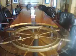 Britannia Yacht Club's Commodore Boardroom features a ship's wheel table