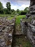 Undercroft of lay brother's range and gap giving entrance to cloister, showing how the building lay separate from the cloister itself.