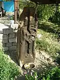 Pillar style khachkar with a Maltese Cross located behind a house in the village.