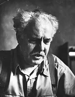 "At his desk focus on his work, probably mathematics or writing"