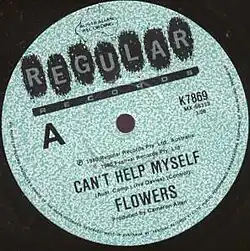 Vinyl single label with word Regular Records written at top. Single title, Can't Help Myself is written across lower half followed by songwriting credit, Iva Davies. Bottom has artist name, Flowers, followed with Produced by Cameron Allan.