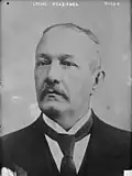 A back-and-white portrait photograph of Carlos Meléndez