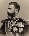 Carol I, king of Romania, wearing the star of the Grand Cross type 1 (to the right).
