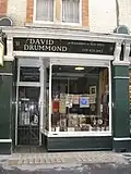 'Pleasures of Past Times', opened by David Drummond in 1967, who was for a time the longest-serving bookseller in Cecil Court. In later years it was run by his son Paul, and it closed in 2019. Currently (2023) Art Deco Gallery.
