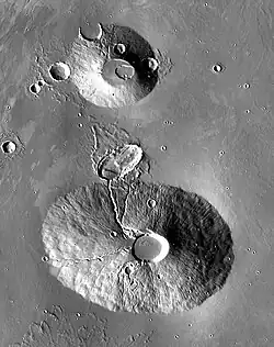 2001 Mars Odyssey THEMIS mosaic of Ceraunius Tholus (lower volcano) and Uranius Tholus (upper volcano). Ceraunius Tholus is about as high as Earth's Mount Everest.