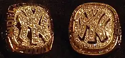 Closeup shot of a gold ring with "NY" in the middle.