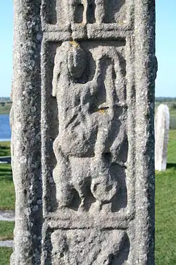 Replica of lyre player on Clonmacnoise Cross of Scriptures, south west view. Image shows round top, and the bundle of strings.