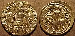 Coin of the Kushan king Kanishka II with, on the reverse, a depiction of Oesho and the word "Oesho" in modified Greek script.
