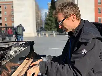 Huggins playing piano in Washington Square Park in January 2019