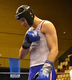A young competitor executing the savate salute