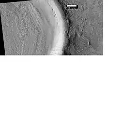 Crater floor, as seen by HiRISE under HiWish program. Rough surface was produced by ice leaving the ground. The crater has accumulated much ice that is covered by rocks and dirt.