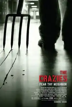 In a school hall, a man stands with a garden fork, with blood marks on the floor. Below the film title printed in red, words in white read "FEAR THY NEIGHBOR".