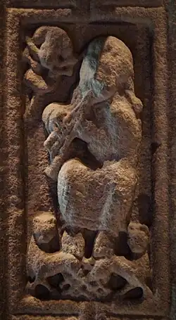 A musician playing triple pipes on the Cross of Scriptures at Clonmacnoise, circa 900 A.D.