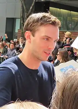 A Caucasian man in a blue sweatshirt looking away from the camera.