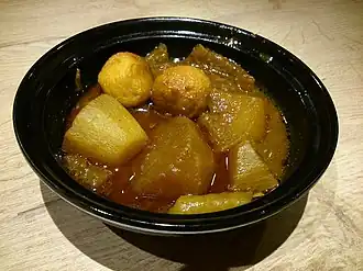 A bowl of curry fish balls, pork rinds and radish sold in Hong Kong