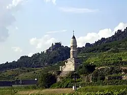A monument stands at the edge of a cliff.