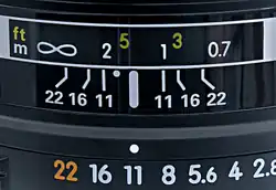 Detail from a lens set to f/11. The point half-way between the 1&nbsp;m and 2&nbsp;m marks, the DOF limits at f/11, represents the focus distance of approximately 1.33&nbsp;m (the reciprocal of the mean of the reciprocals of 1 and 2 being 4/3).