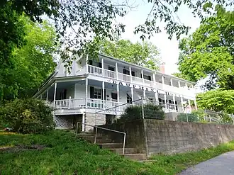 A two storey, white building with the text Dauphine Hotel displayed on the exterior.