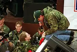 Shane Minor singing to a US soldier at Tuzla Air Base, Bosnia and Herzegovina, in 1999.