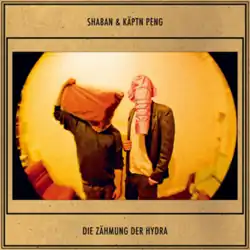 Cover featuring a fisheye lens photo of the musicians with both their faces covered