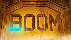 Text reading "Boom" in all caps against a rusty metal door.