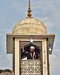 The head cleric displaying the hair on Mawlid in 2018