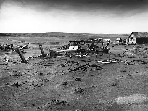Image 8 Dust Bowl Photo credit: Sloan, USDA Buried machinery in a barn lot, Dallas, South Dakota, United States, due to Dust Bowl conditions, May 1936. Dust storms from 1930–1939 caused major ecological and agricultural damage to American and Canadian prairie lands. This ecological disaster was a result of drought conditions coupled with decades of extensive farming using techniques that promoted erosion. More featured pictures
